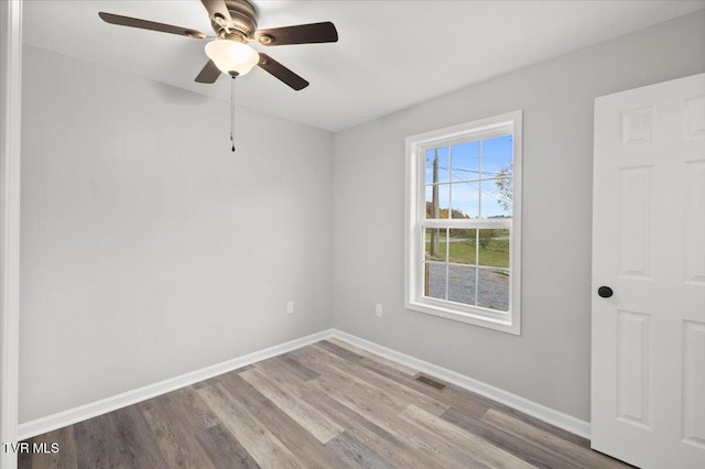 unfurnished room featuring ceiling fan and hardwood / wood-style flooring