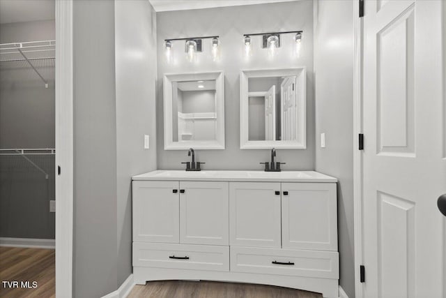 bathroom with vanity and wood-type flooring