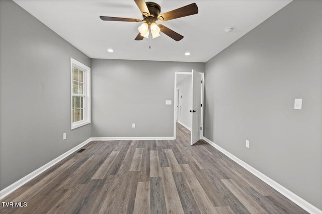 empty room with hardwood / wood-style floors and ceiling fan