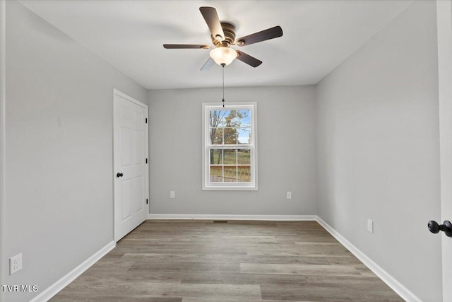 spare room featuring light hardwood / wood-style flooring and ceiling fan