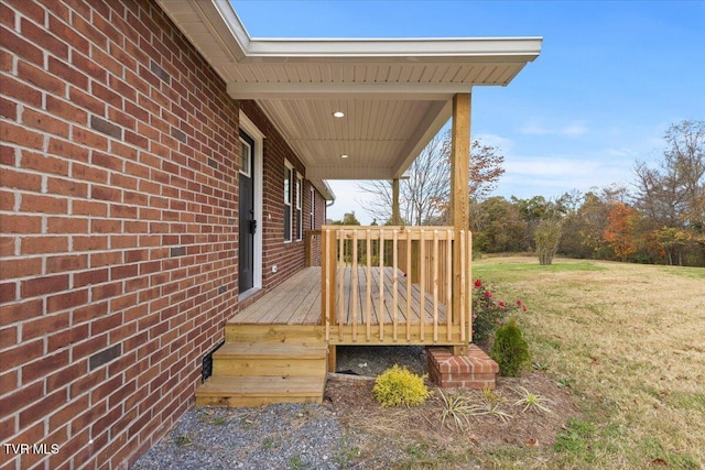 wooden terrace featuring a yard