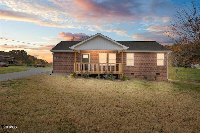 exterior space featuring covered porch and a yard