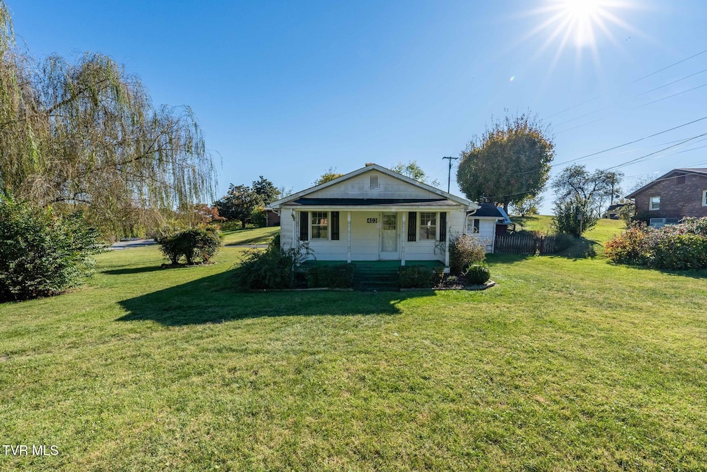 view of front of house with a porch and a front lawn