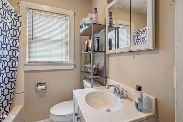 full bathroom with vanity, shower / tub combo, and toilet