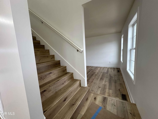 stairway featuring hardwood / wood-style floors