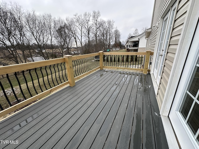 wooden deck with a lawn