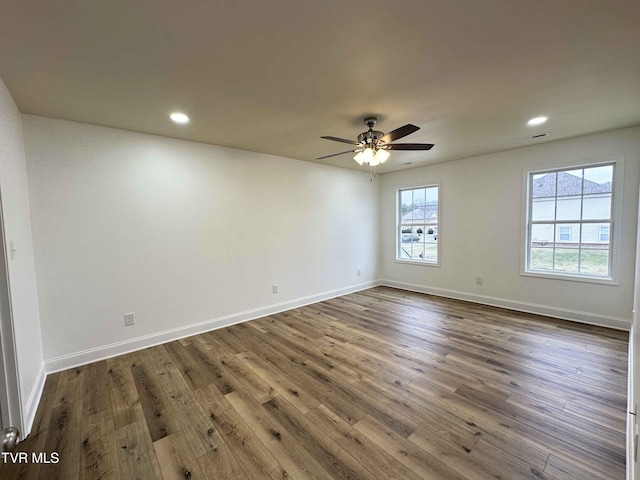 empty room featuring dark hardwood / wood-style floors and ceiling fan