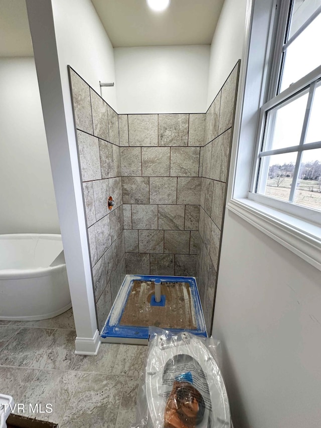 bathroom featuring separate shower and tub