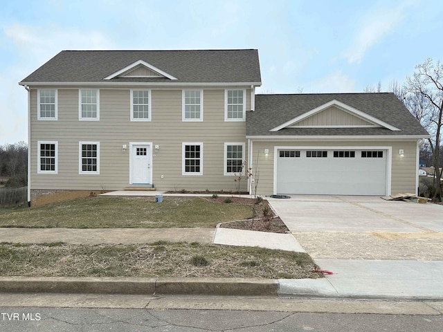 colonial inspired home with a garage and a front lawn