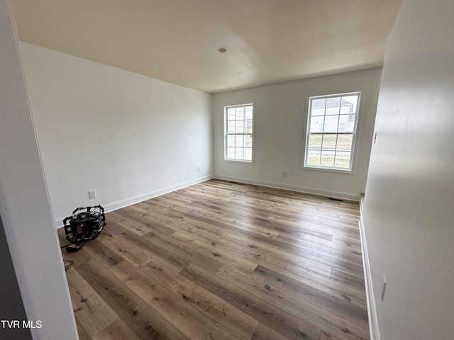 spare room with wood-type flooring