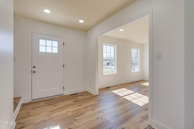 foyer featuring visible vents, recessed lighting, light wood-type flooring, and baseboards