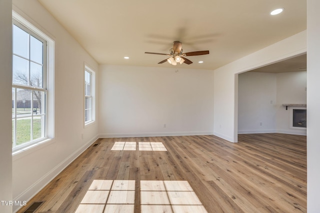 unfurnished room with recessed lighting, visible vents, light wood-style flooring, and a fireplace