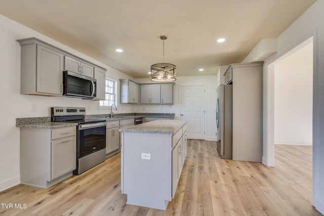 kitchen featuring a sink, appliances with stainless steel finishes, and gray cabinets