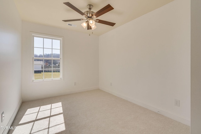 unfurnished room with visible vents, baseboards, carpet, and ceiling fan