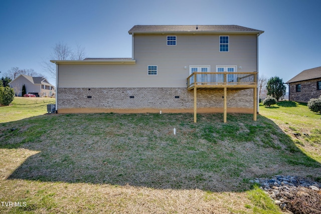 rear view of property with a deck and a lawn