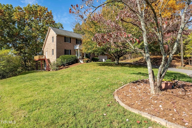 view of front of property featuring a front yard and a deck