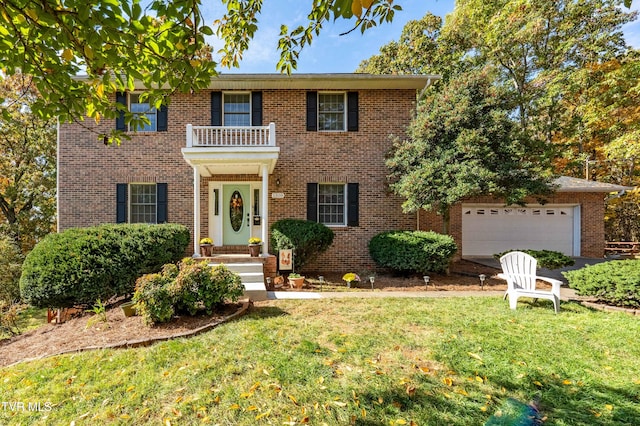 colonial home featuring a front lawn and a balcony