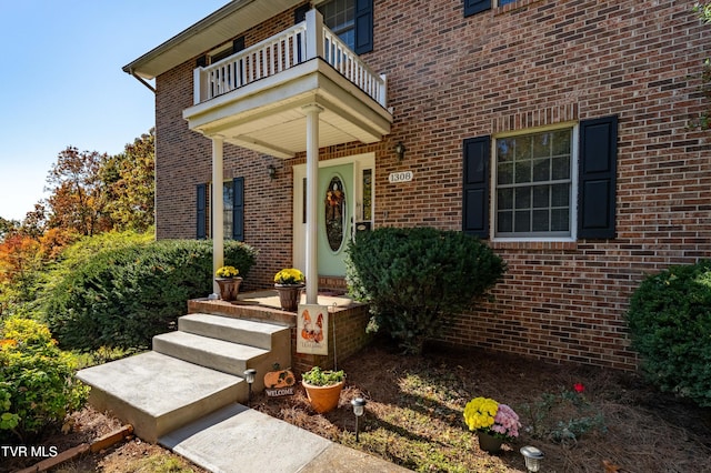 view of exterior entry featuring a balcony