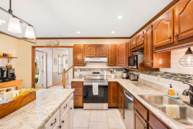 kitchen with decorative backsplash, stainless steel appliances, sink, pendant lighting, and light tile patterned floors