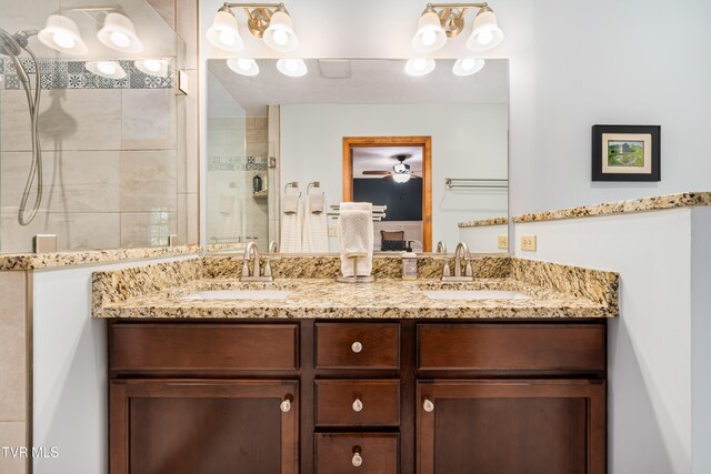 bathroom featuring vanity and tiled shower