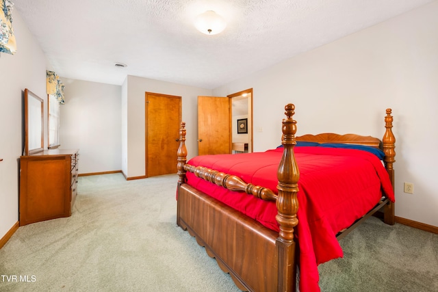 carpeted bedroom featuring a textured ceiling