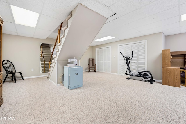 workout area with carpet and a paneled ceiling