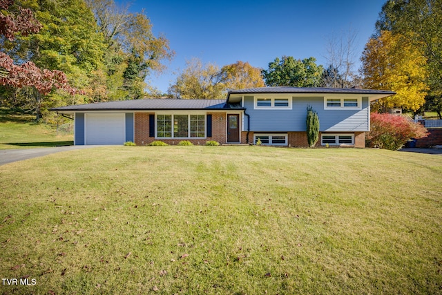 tri-level home featuring a front yard and a garage