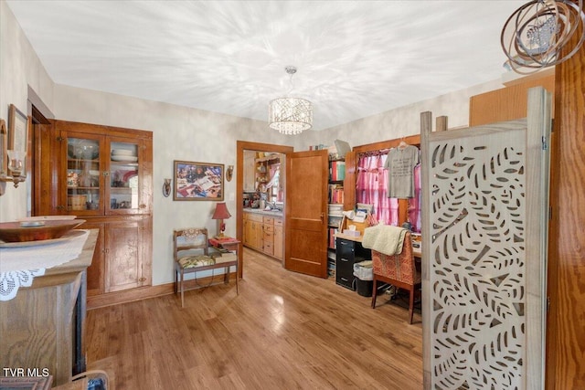 office area with an inviting chandelier and light hardwood / wood-style floors