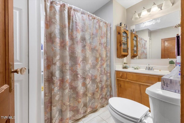 bathroom with walk in shower, vanity, toilet, and tile patterned flooring