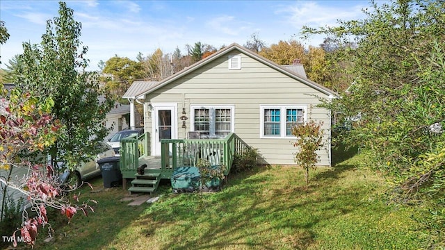 rear view of property featuring a yard