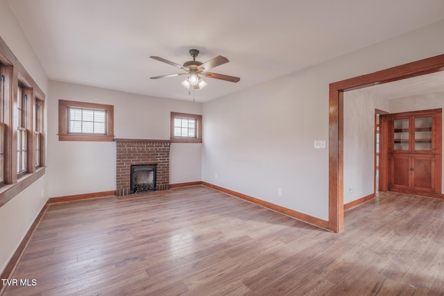 unfurnished living room with light hardwood / wood-style flooring, a fireplace, and ceiling fan