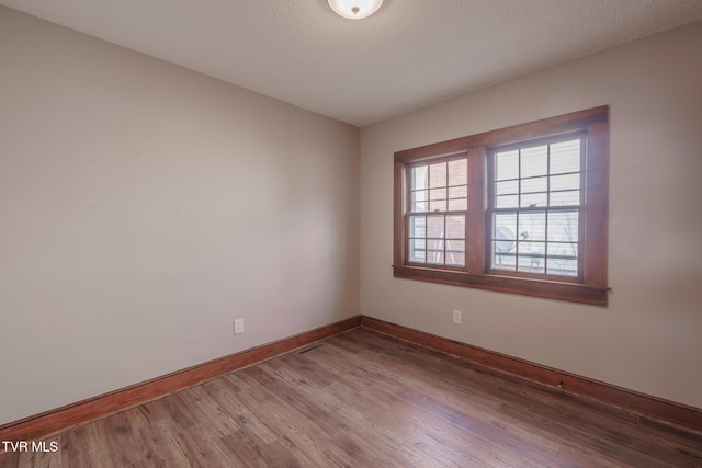 unfurnished room featuring hardwood / wood-style flooring