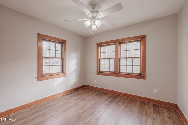 spare room with ceiling fan and light hardwood / wood-style flooring