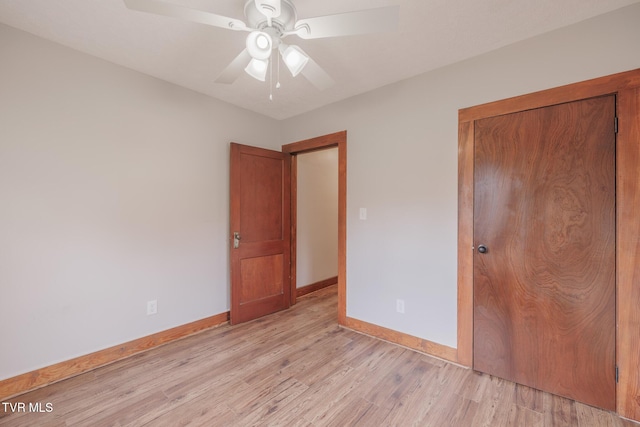 unfurnished bedroom featuring light hardwood / wood-style floors, a closet, and ceiling fan