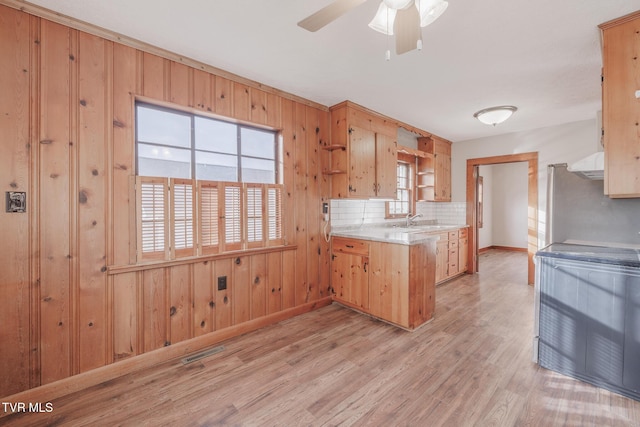 kitchen featuring sink, electric range, light wood-type flooring, ceiling fan, and backsplash