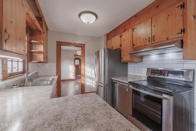 kitchen featuring stainless steel appliances, tasteful backsplash, and sink