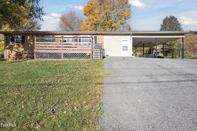 view of front of house with a front yard, a deck, and a carport