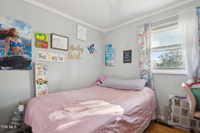 bedroom featuring crown molding and hardwood / wood-style flooring