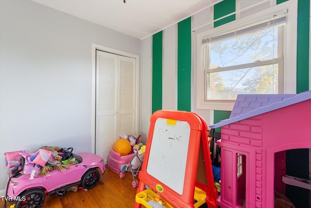 recreation room with hardwood / wood-style floors