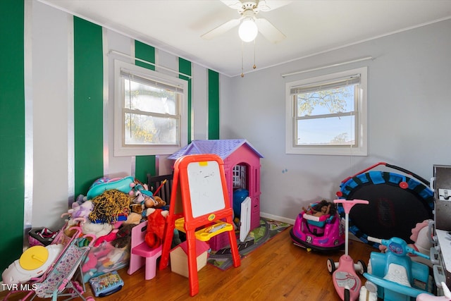 rec room with hardwood / wood-style flooring and ceiling fan