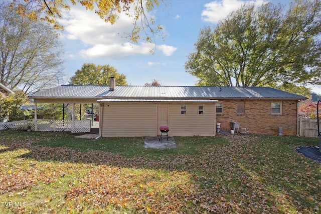 rear view of house featuring a yard and a patio area