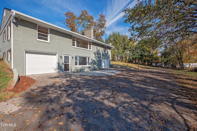 rear view of property with a garage