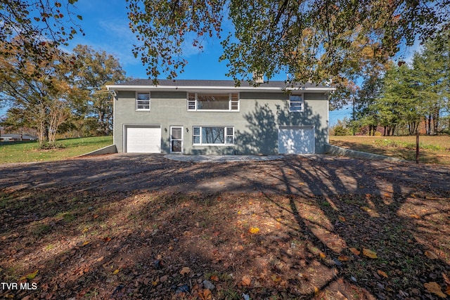 back of property featuring a garage