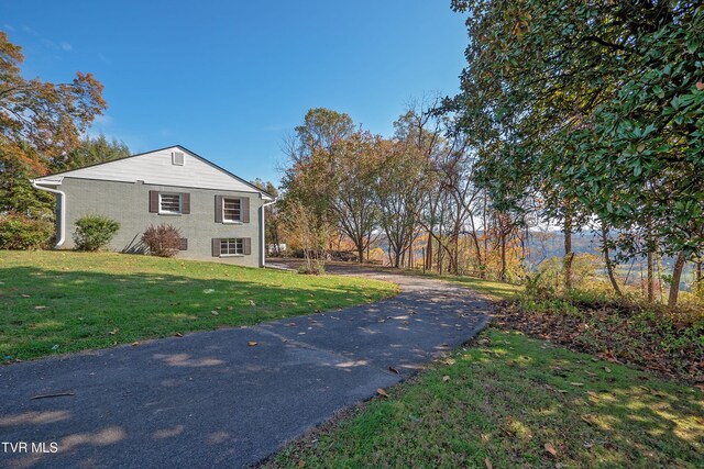 view of home's exterior with a lawn