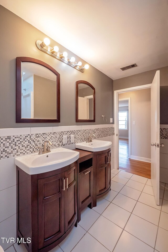 bathroom with vanity, tile walls, and tile patterned flooring