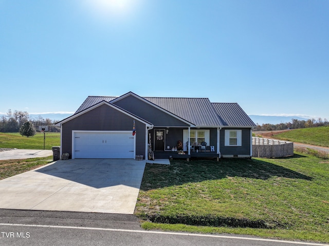 view of front of property with covered porch, a garage, and a front lawn