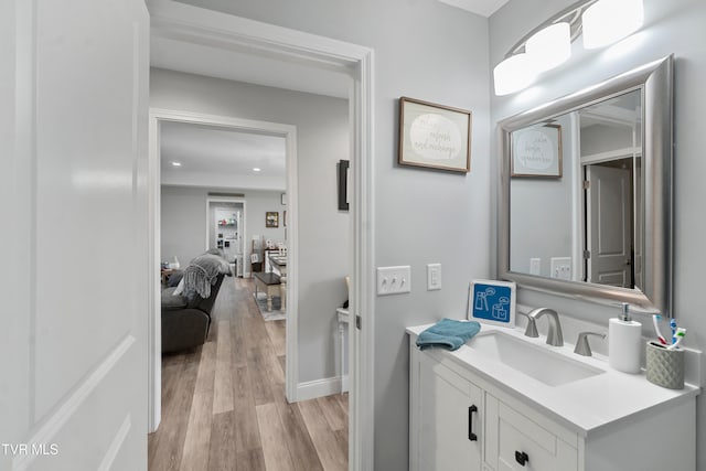 bathroom with vanity and wood-type flooring