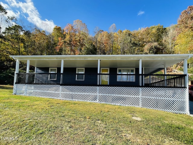 view of home's exterior featuring a wooden deck and a lawn