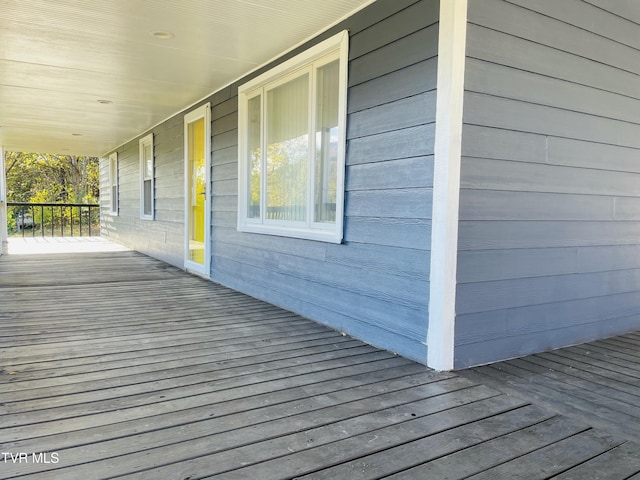 wooden terrace featuring covered porch