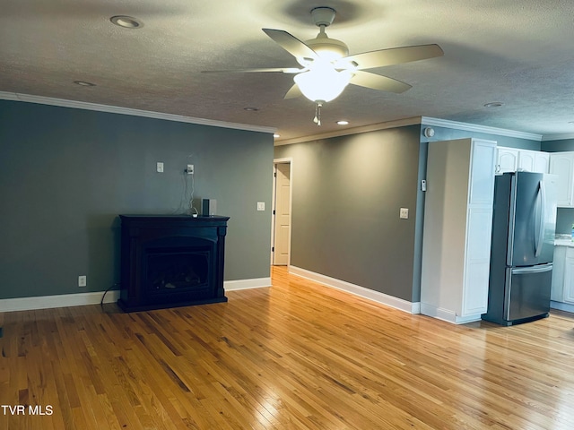 unfurnished living room with crown molding, light hardwood / wood-style flooring, and ceiling fan